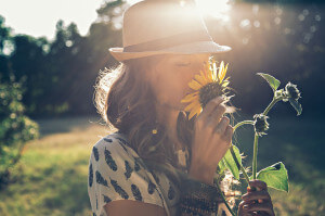 Girl smells sunflower