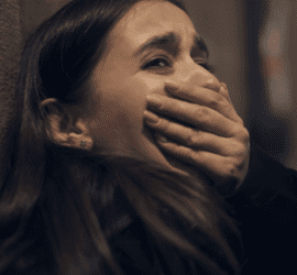 trauma - woman gasping and covering her mouth