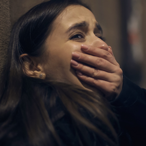 trauma - woman gasping and covering her mouth