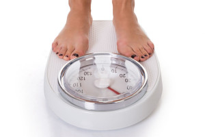Weight Management Low Section Of Woman Standing On Weighing Scale